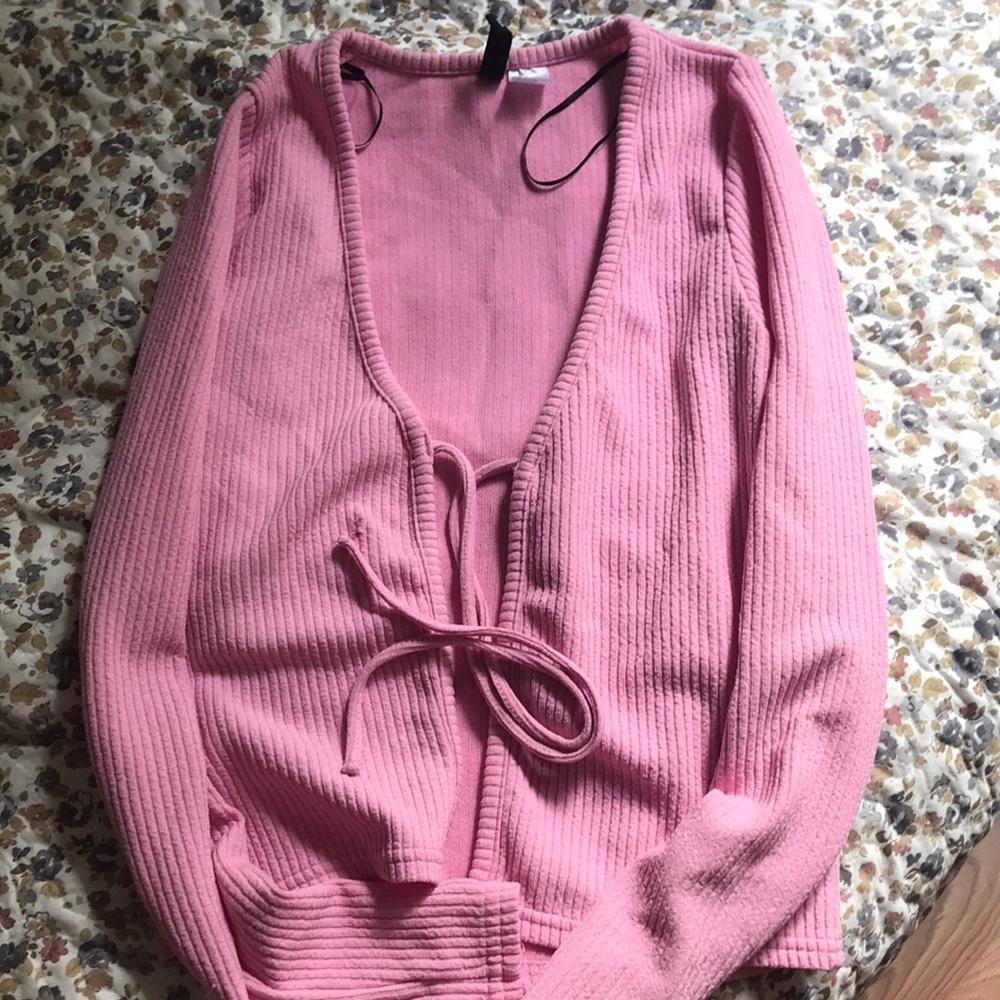 I am selling a cute long light pink top.